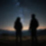 Silhouette of two individuals chatting under a starry sky