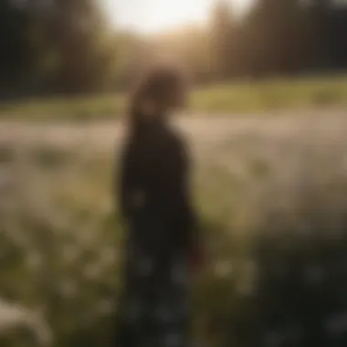 Silhouette of a person standing in a field of blooming flowers