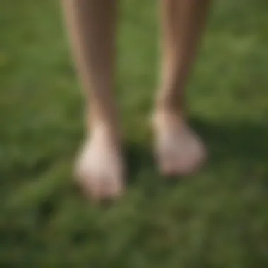 Person walking barefoot on grass for grounding