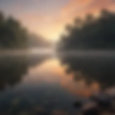 Sunrise over a tranquil lake with misty clouds reflecting in the water