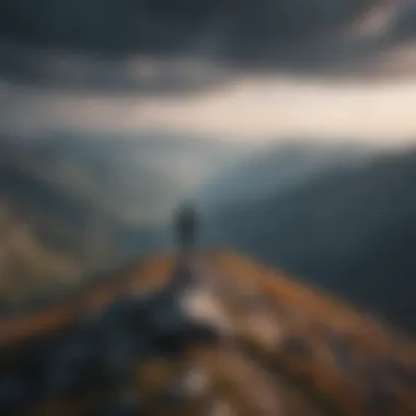 Person standing on mountaintop looking towards the horizon