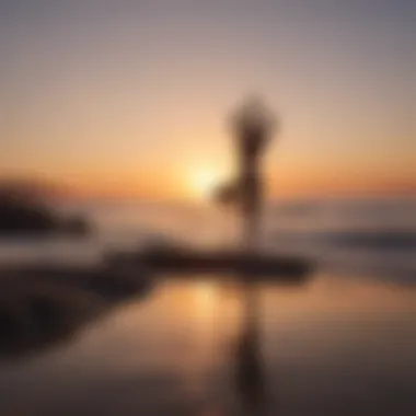 Sunrise over calm ocean with silhouette of person practicing yoga