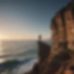 Silhouette of a person standing alone on a cliff overlooking the ocean