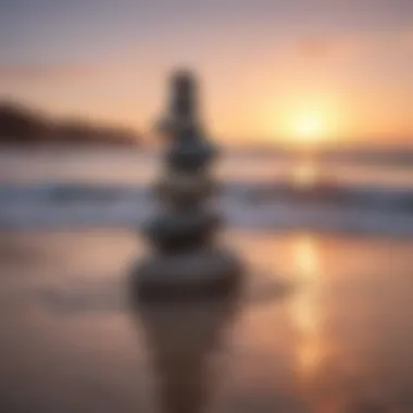 A stack of balanced stones on a serene beach at sunrise