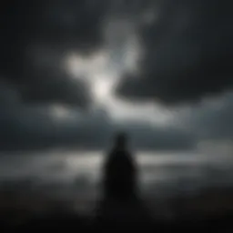 Silhouette of a person sitting alone with dark clouds overhead