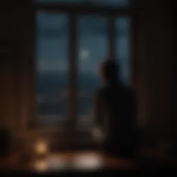 Silhouette of a person looking out a window at night