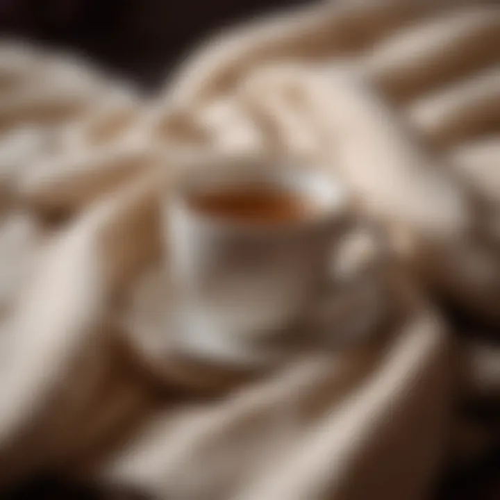 A close-up of a teacup and a warm blanket, evoking comfort